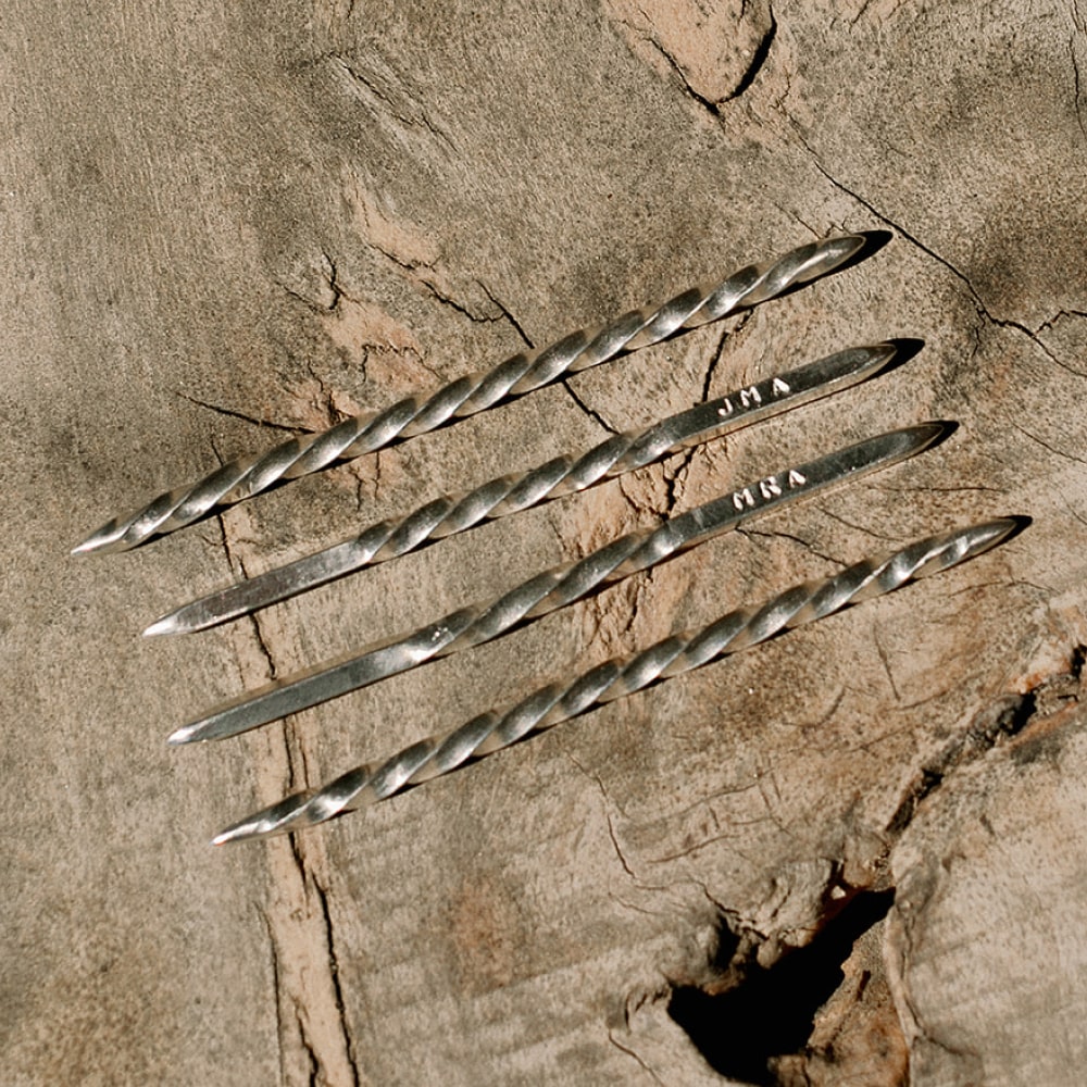 A group of Cowboy Toothpicks by Shop Marian on a wood surface.