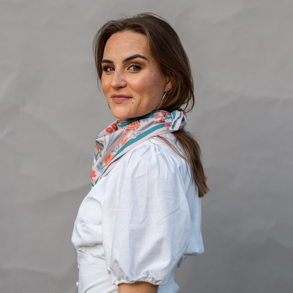 a woman wearing a white shirt and a Shop Marian Darling Scarf.