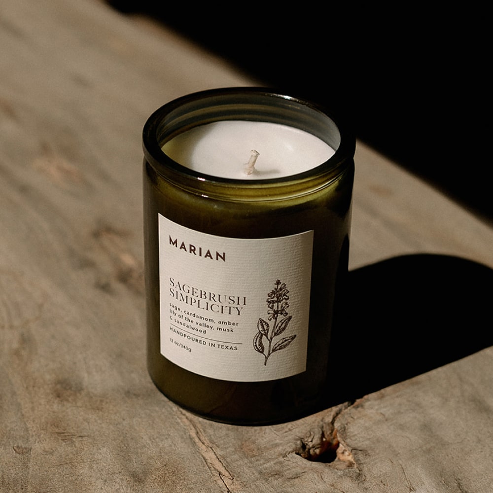 a Sagebrush Simplicity candle sitting on a wooden table by Shop Marian.