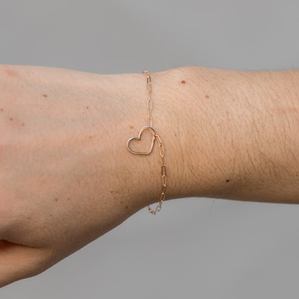 A woman's wrist with a Take Heart Bracelet by Shop Marian.