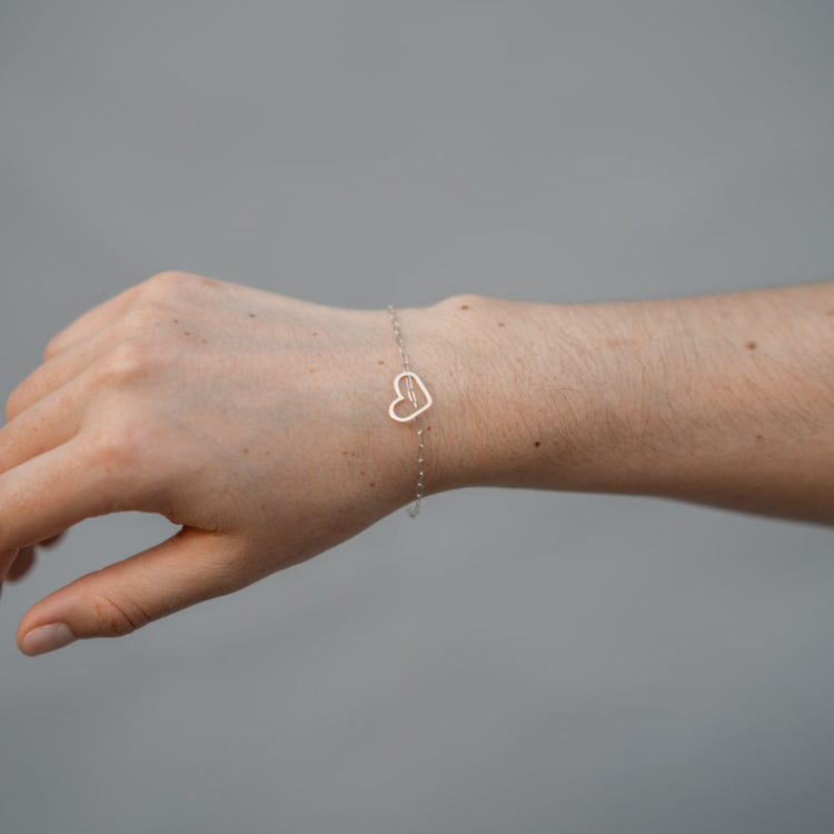 A woman's wrist with a Shop Marian Take Heart Bracelet.