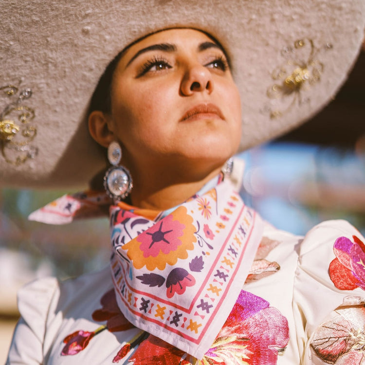 a woman wearing a ¡VIVA! Scarf and Shop Marian mexican hat.